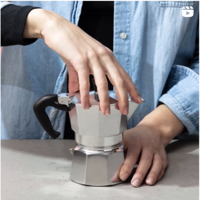 moka pot with hands
